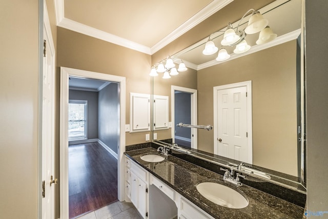 bathroom with hardwood / wood-style flooring, vanity, and ornamental molding