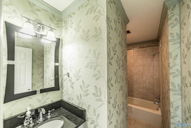 bathroom featuring vanity, tiled shower / bath combo, tile patterned floors, and ornamental molding