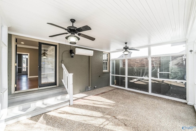 unfurnished sunroom with an AC wall unit and ceiling fan