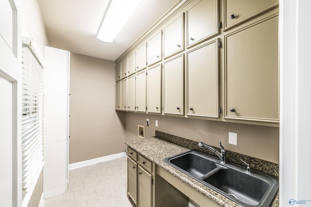 kitchen with light tile patterned flooring, dark stone countertops, and sink