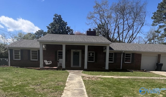 view of front of house with a garage, a front lawn, and a porch