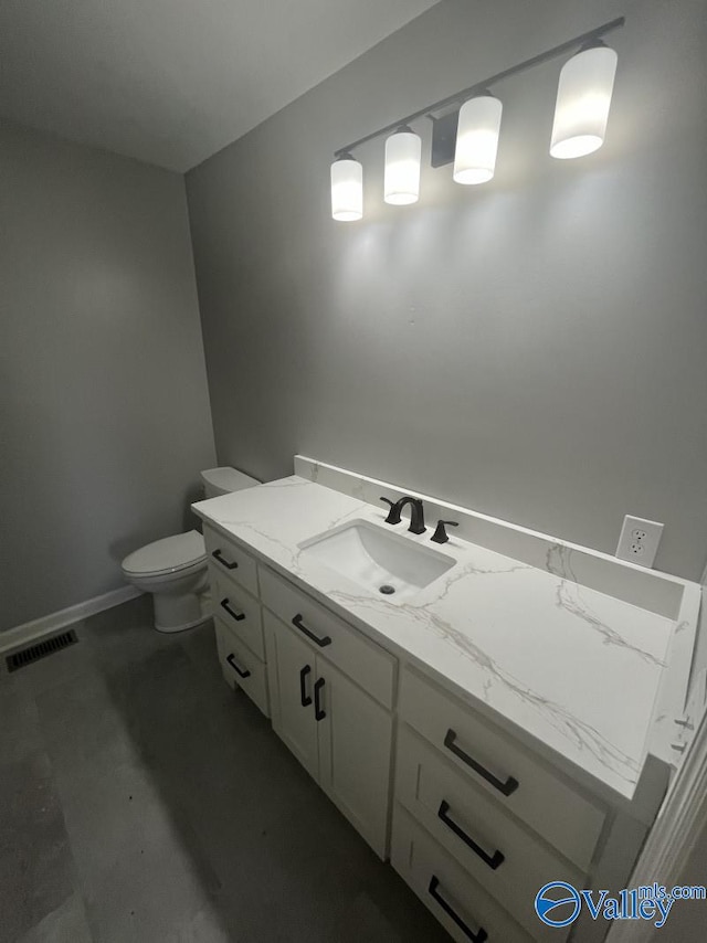 bathroom featuring vanity and toilet