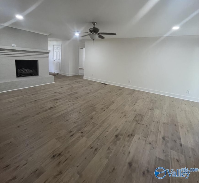 unfurnished living room featuring hardwood / wood-style floors and ceiling fan