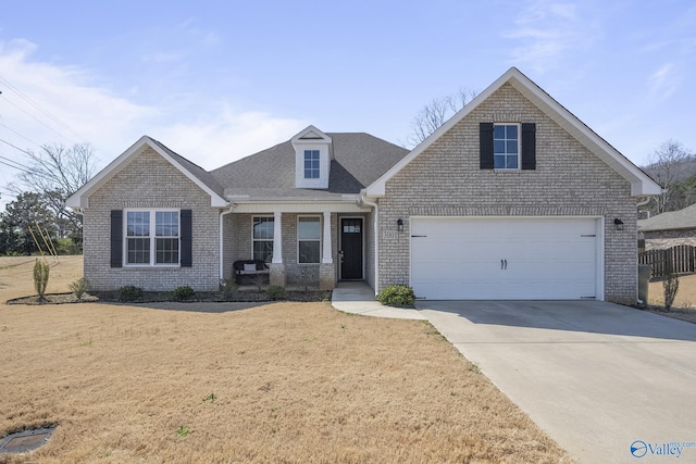 view of front facade with brick siding, roof with shingles, concrete driveway, and a front lawn