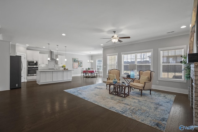 interior space with dark wood finished floors, a ceiling fan, and ornamental molding