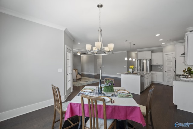 dining space with baseboards, dark wood-type flooring, an inviting chandelier, and crown molding