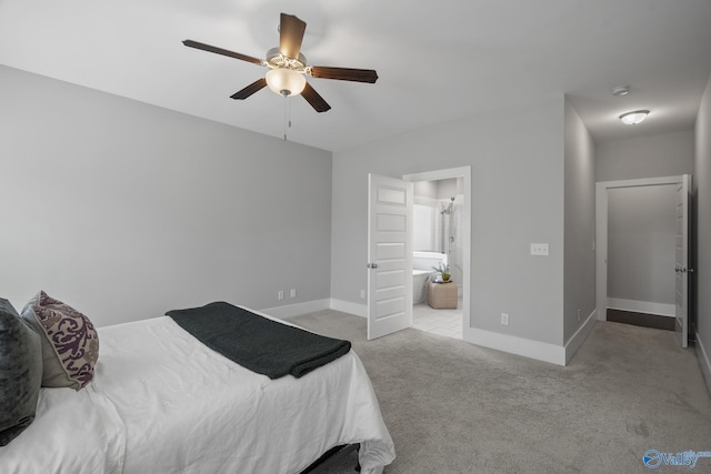 carpeted bedroom featuring connected bathroom, baseboards, and ceiling fan