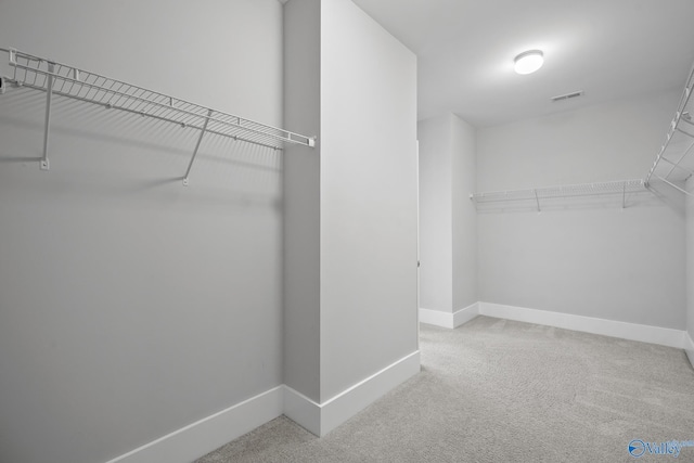 spacious closet with visible vents and carpet floors