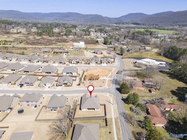 birds eye view of property with a mountain view and a residential view