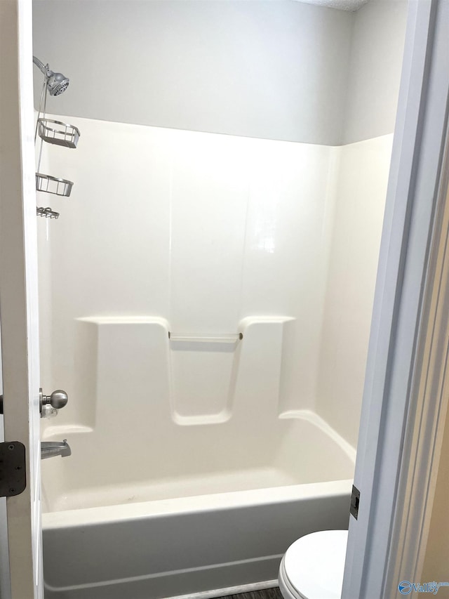 full bathroom featuring tub / shower combination and toilet