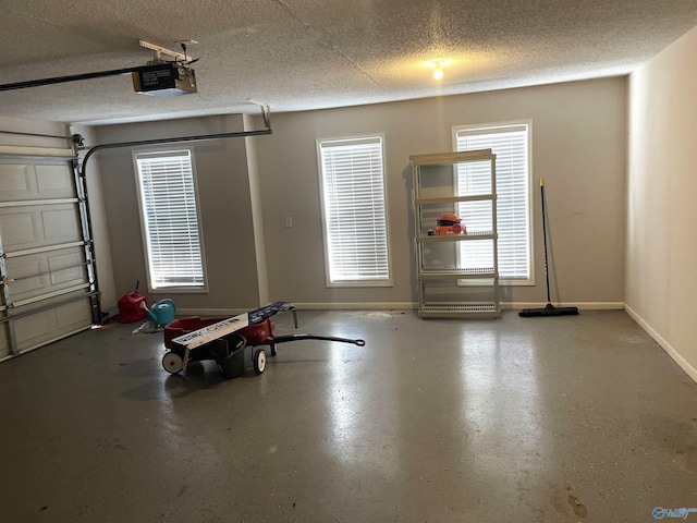 garage with a garage door opener and baseboards