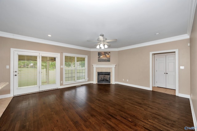 22656 Riviera Dr, Athens, AL 35613 - unfurnished living room featuring a ceiling fan, crown molding, wood finished floors, baseboards, and a tiled fireplace