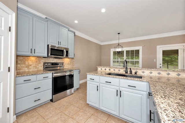 22656 Riviera Dr, Athens, AL 35613 - kitchen with appliances with stainless steel finishes, a sink, tasteful backsplash, crown molding, and plenty of natural light