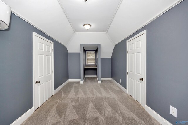 22656 Riviera Dr, Athens, AL 35613 - additional living space with carpet flooring, a wall mounted air conditioner, vaulted ceiling, and baseboards