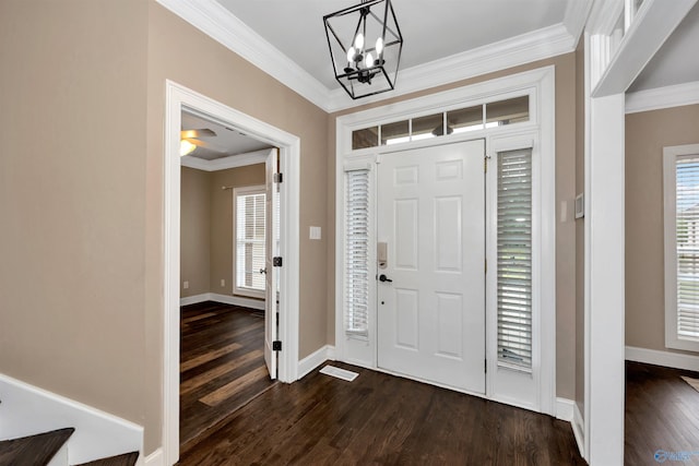 22656 Riviera Dr, Athens, AL 35613 - foyer with ornamental molding, dark wood-style floors, a chandelier, and baseboards