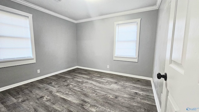 spare room featuring dark wood-type flooring and ornamental molding