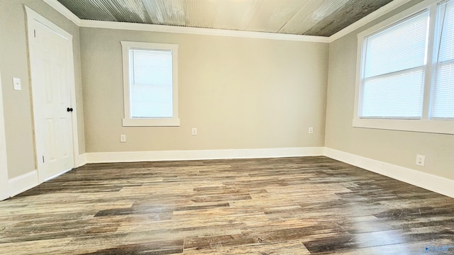 unfurnished room featuring ornamental molding and dark wood-type flooring