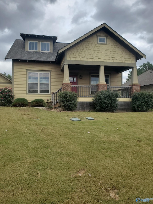 craftsman-style house with covered porch and a front lawn