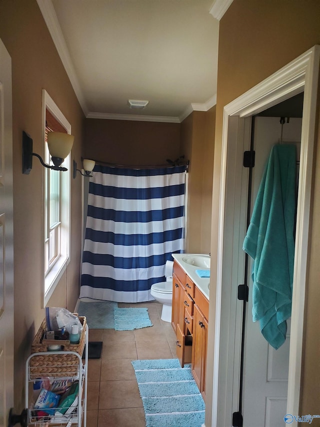 bathroom with tile patterned floors, vanity, toilet, and ornamental molding