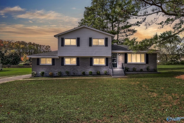 split level home featuring a lawn