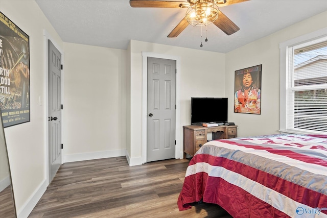 bedroom featuring ceiling fan, baseboards, and wood finished floors