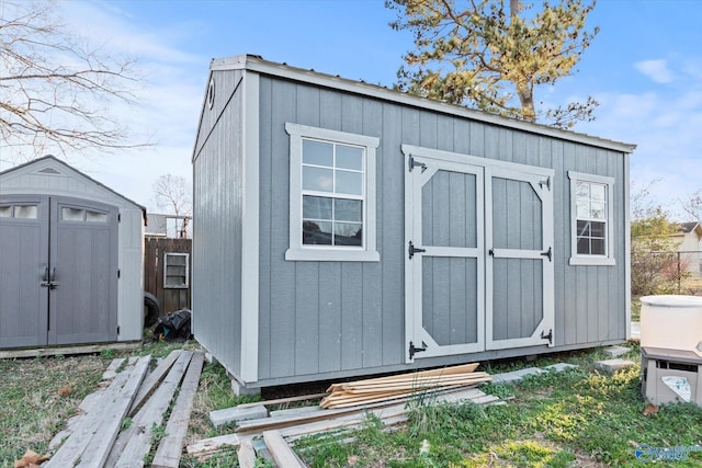 view of shed featuring fence