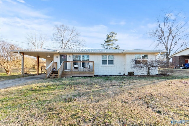 ranch-style home featuring metal roof, crawl space, a front lawn, a carport, and brick siding