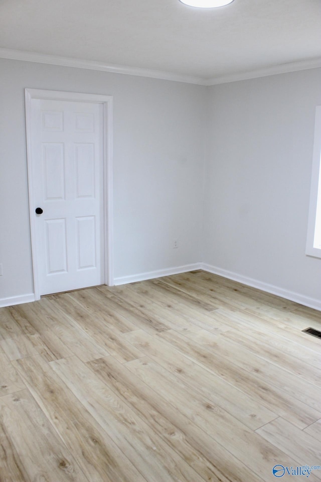 unfurnished room with crown molding and light wood-type flooring