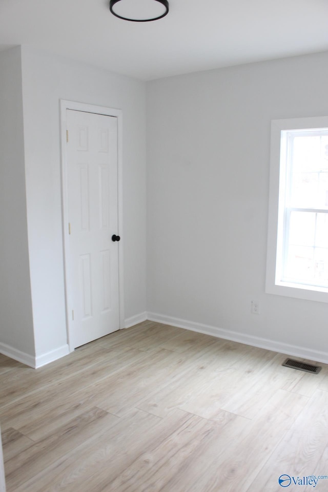 spare room featuring light wood-type flooring