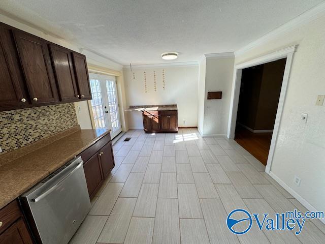 kitchen with dark brown cabinetry, french doors, stainless steel dishwasher, and ornamental molding