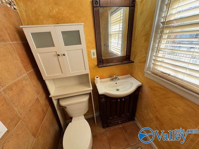 bathroom featuring tile patterned flooring, vanity, and toilet