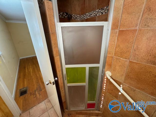 bathroom with tile patterned flooring and crown molding