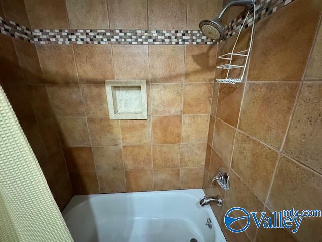 bathroom with shower / tub combo with curtain