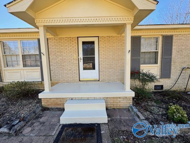 view of exterior entry featuring a porch