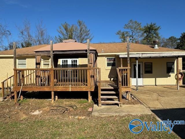 back of property with a gazebo, a patio area, and a wooden deck