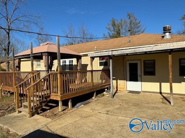 back of property with a wooden deck