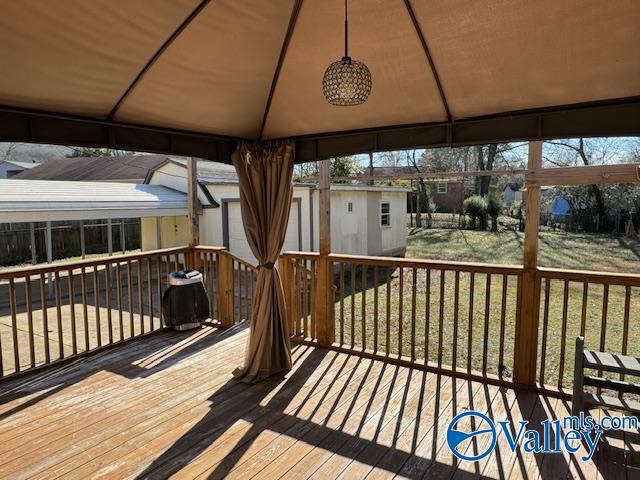 wooden deck with a gazebo and a yard