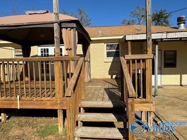 wooden deck featuring a gazebo