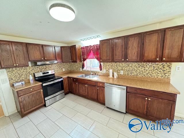 kitchen with decorative backsplash, sink, and appliances with stainless steel finishes