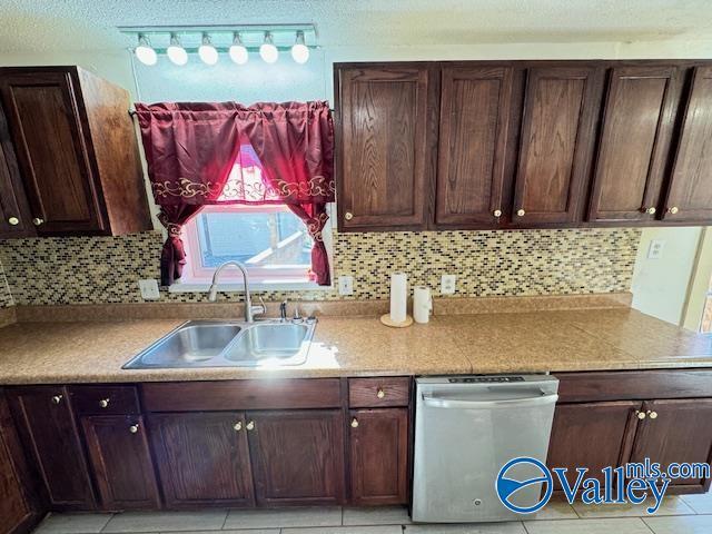 kitchen with dishwasher, backsplash, and sink