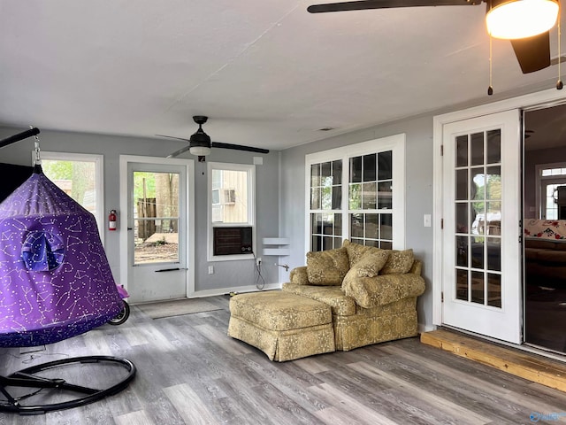 living room featuring wood-type flooring and ceiling fan