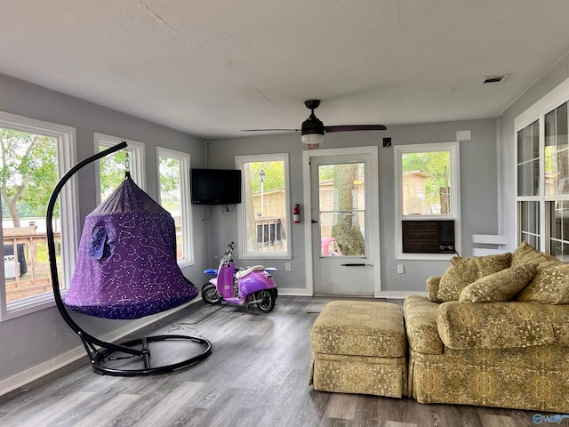 living room featuring ceiling fan and hardwood / wood-style flooring