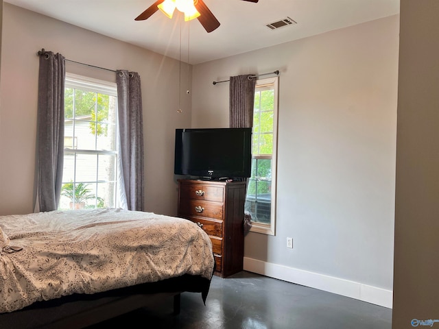 bedroom with ceiling fan and multiple windows