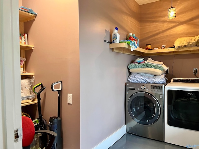 clothes washing area with separate washer and dryer