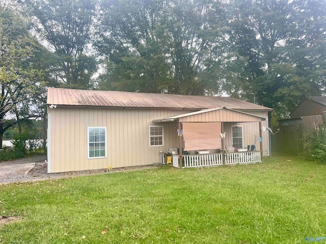 back of property featuring a lawn