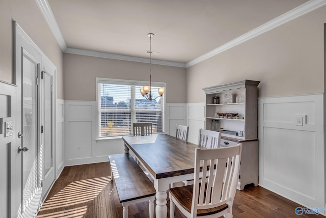 dining room with ornamental molding, dark wood-type flooring, and a notable chandelier