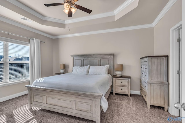 carpeted bedroom featuring ornamental molding, ceiling fan, and a tray ceiling