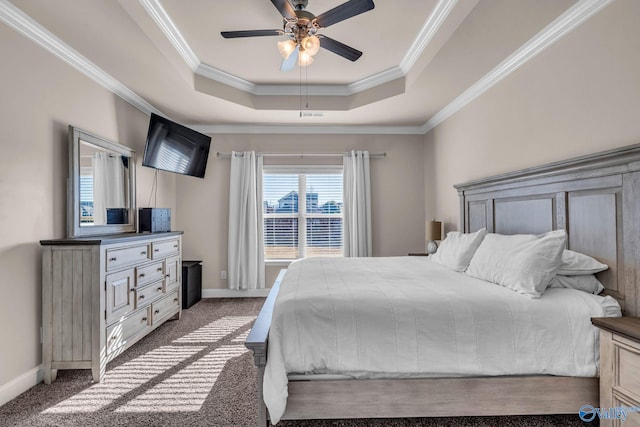 carpeted bedroom featuring crown molding, a tray ceiling, and ceiling fan