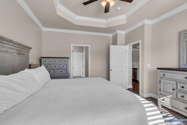 bedroom featuring crown molding, a raised ceiling, and ceiling fan