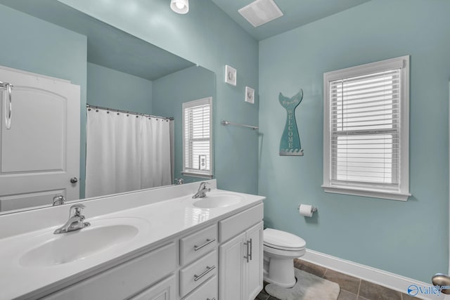 bathroom featuring tile patterned floors, vanity, toilet, and curtained shower